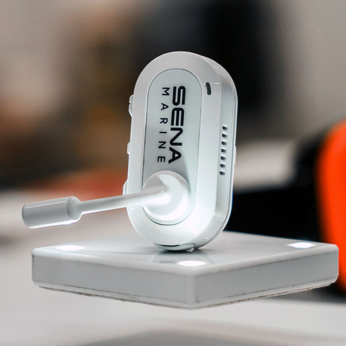 A white Sena Marine electronic device mounted on a matching white display stand, photographed in a clean indoor setting with a blurred background.